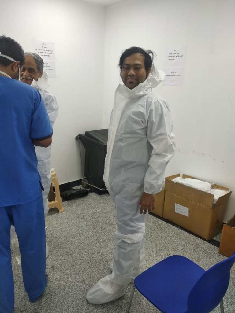Researcher preparing protective equipment during the COVID-19 response, April 2020